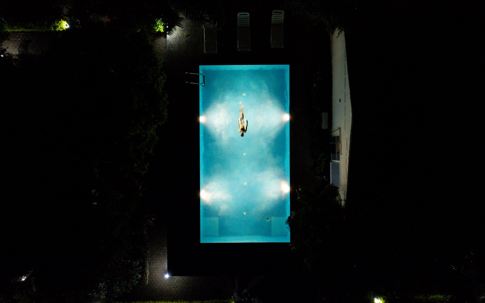 Wide aerial night view of the property