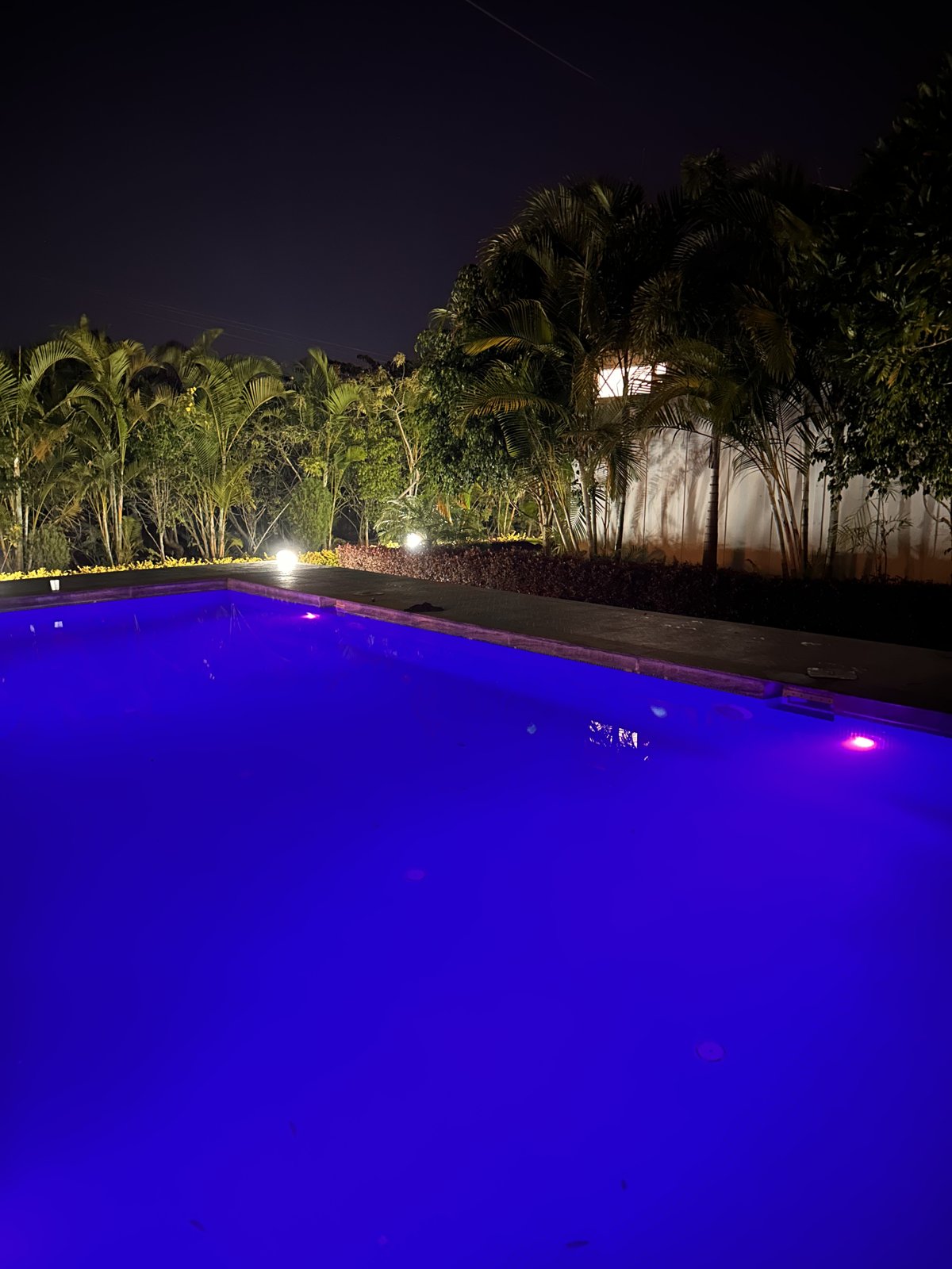 Pool lit up blue at night